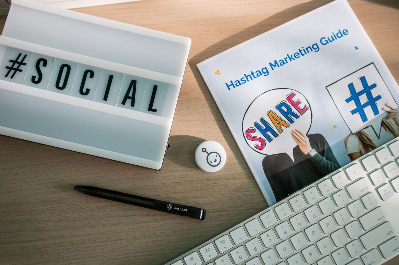 Home A desktop setup with social media marketing essentials including a keyboard, lightbox, and guide.