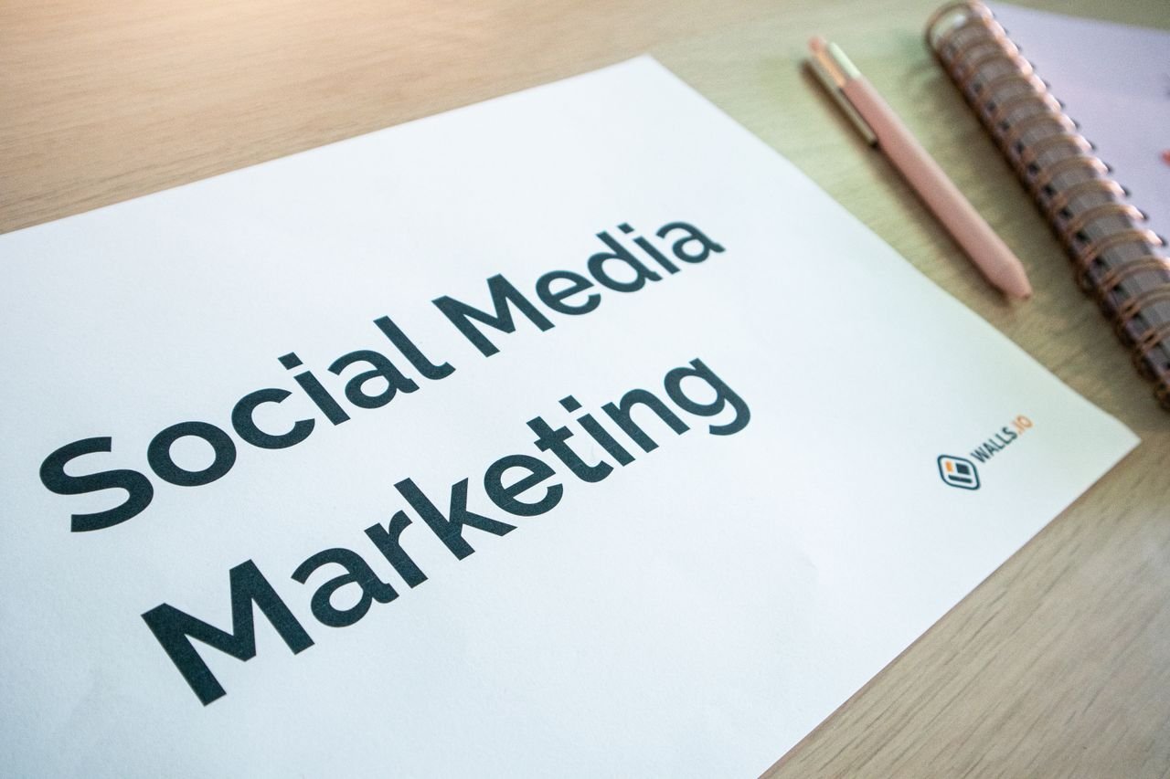 Home Close-up of a social media marketing document on a desk with a pen and notebook.