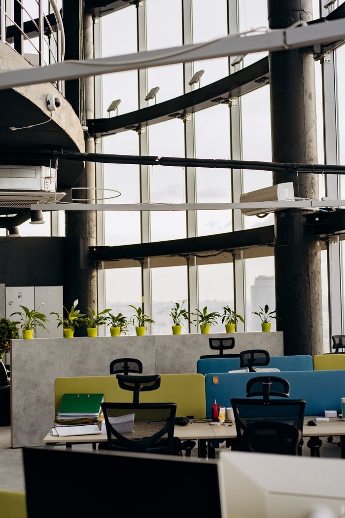 Services Stylish contemporary office interior with plants and large windows.